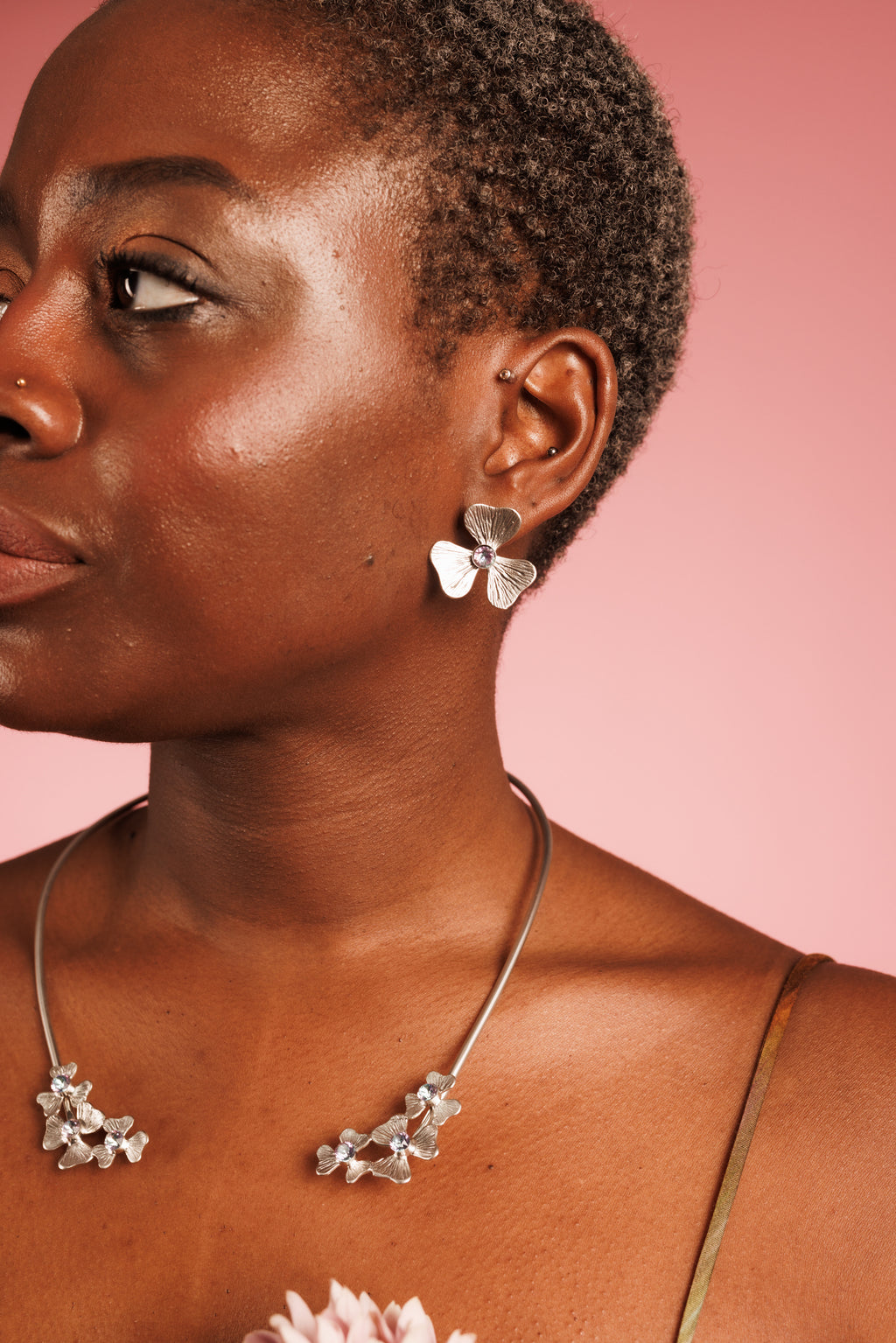 statement silver flower stud earrings with purple crystal, and silver open cuff floral necklace with three flowers and velvet crystal cubic zirconia
