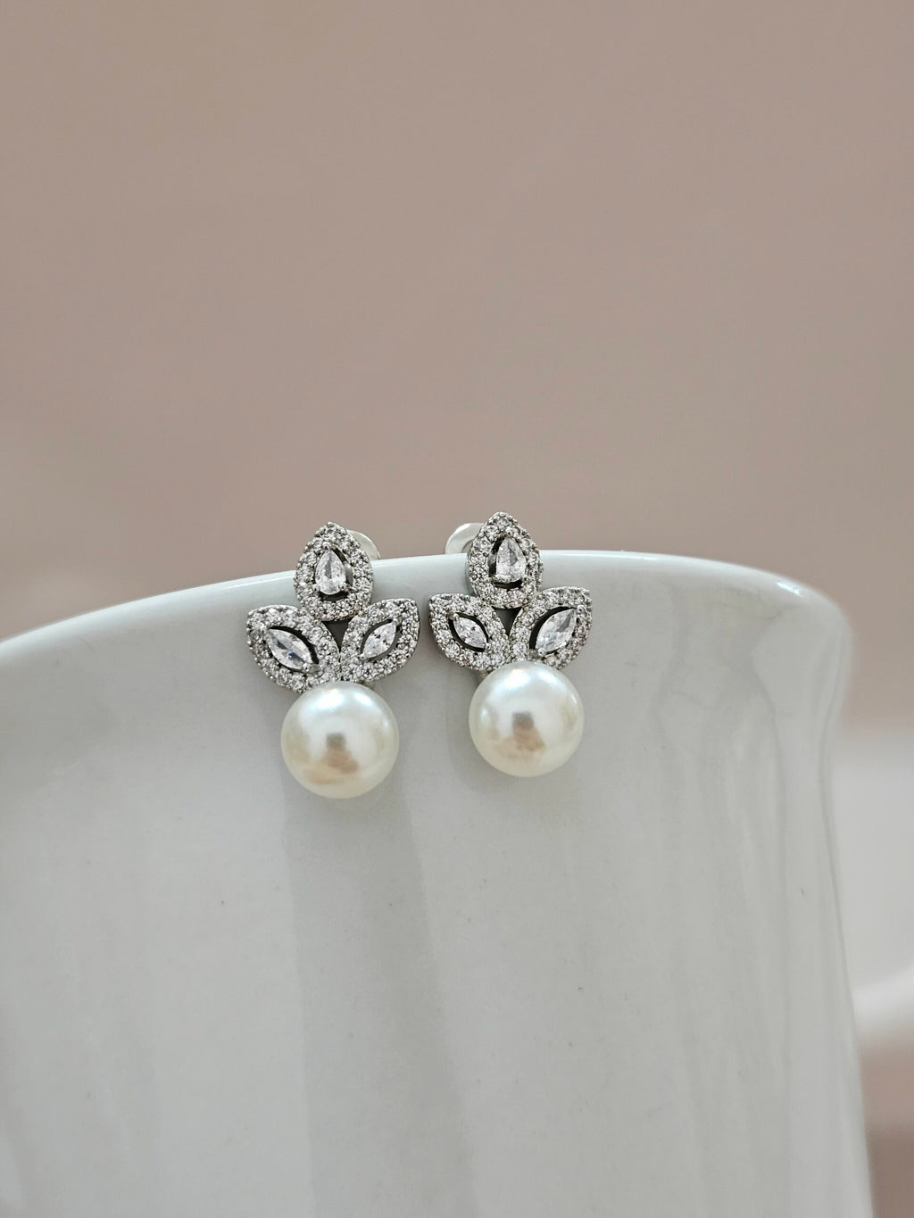 three crystal zirconia earrings with a round pearl